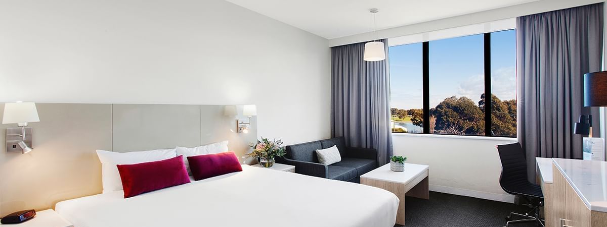 King bed and seating in Mercure Superior Lakeview Room at Pullman Albert Park