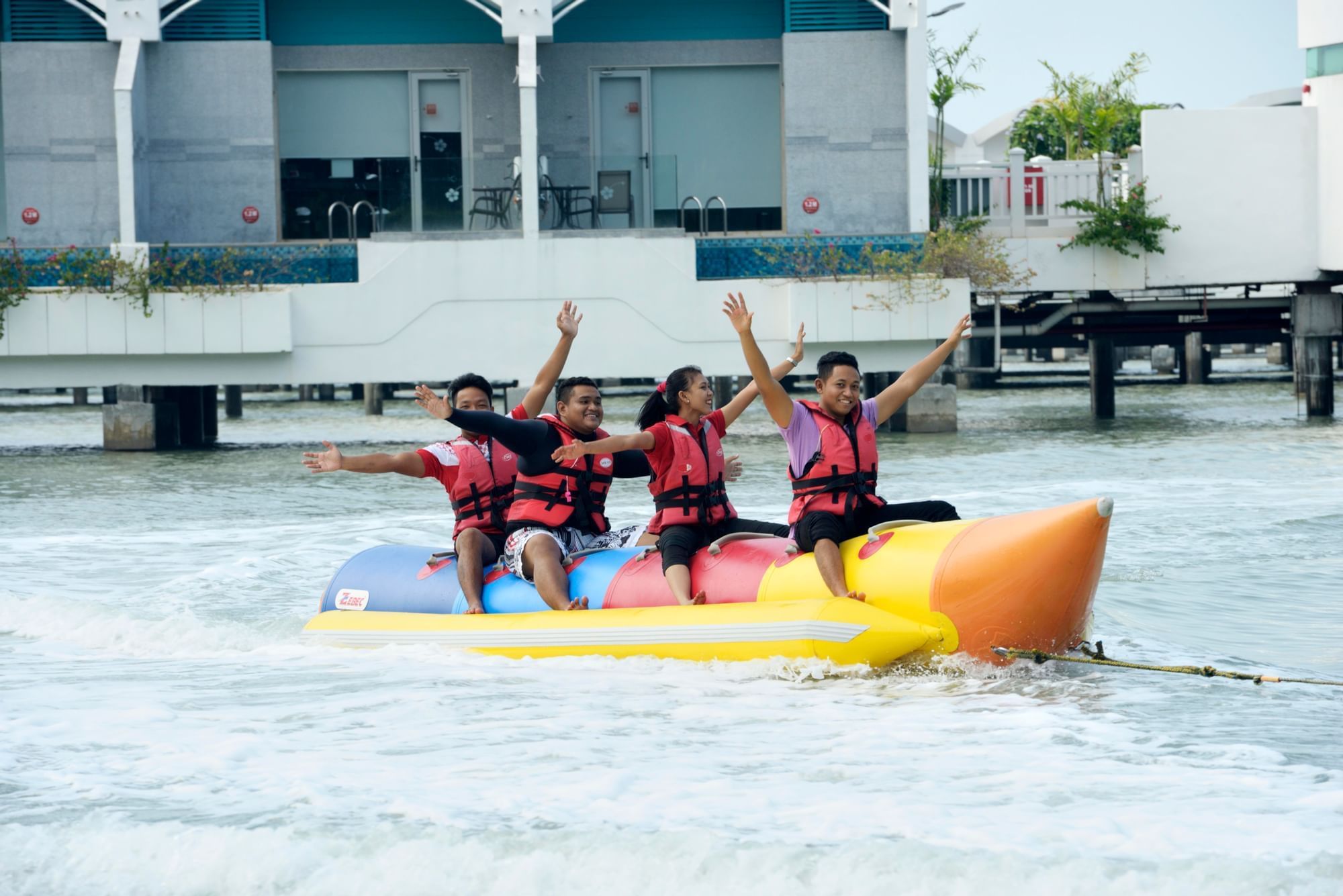 A group of people playing the banana boat - Lexis Hibiscus