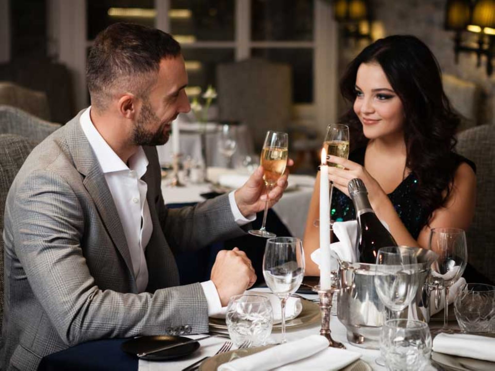 Couple sharing a romantic toast with champagne at Crystal Inn Salt Lake City