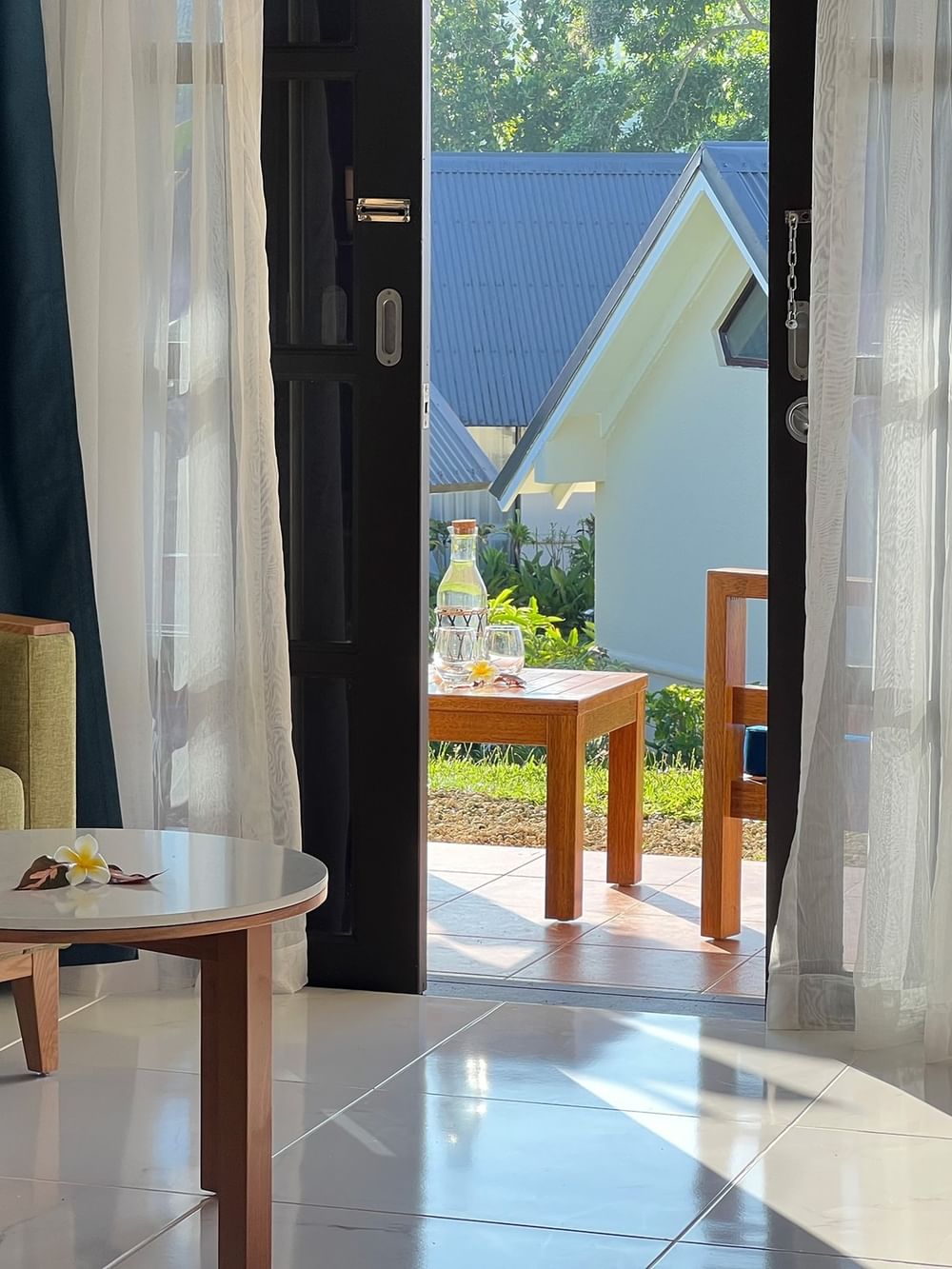Garden view room with chairs, tables, and outdoor seating at Warwick Le Lagon - Vanuatu in Efate.