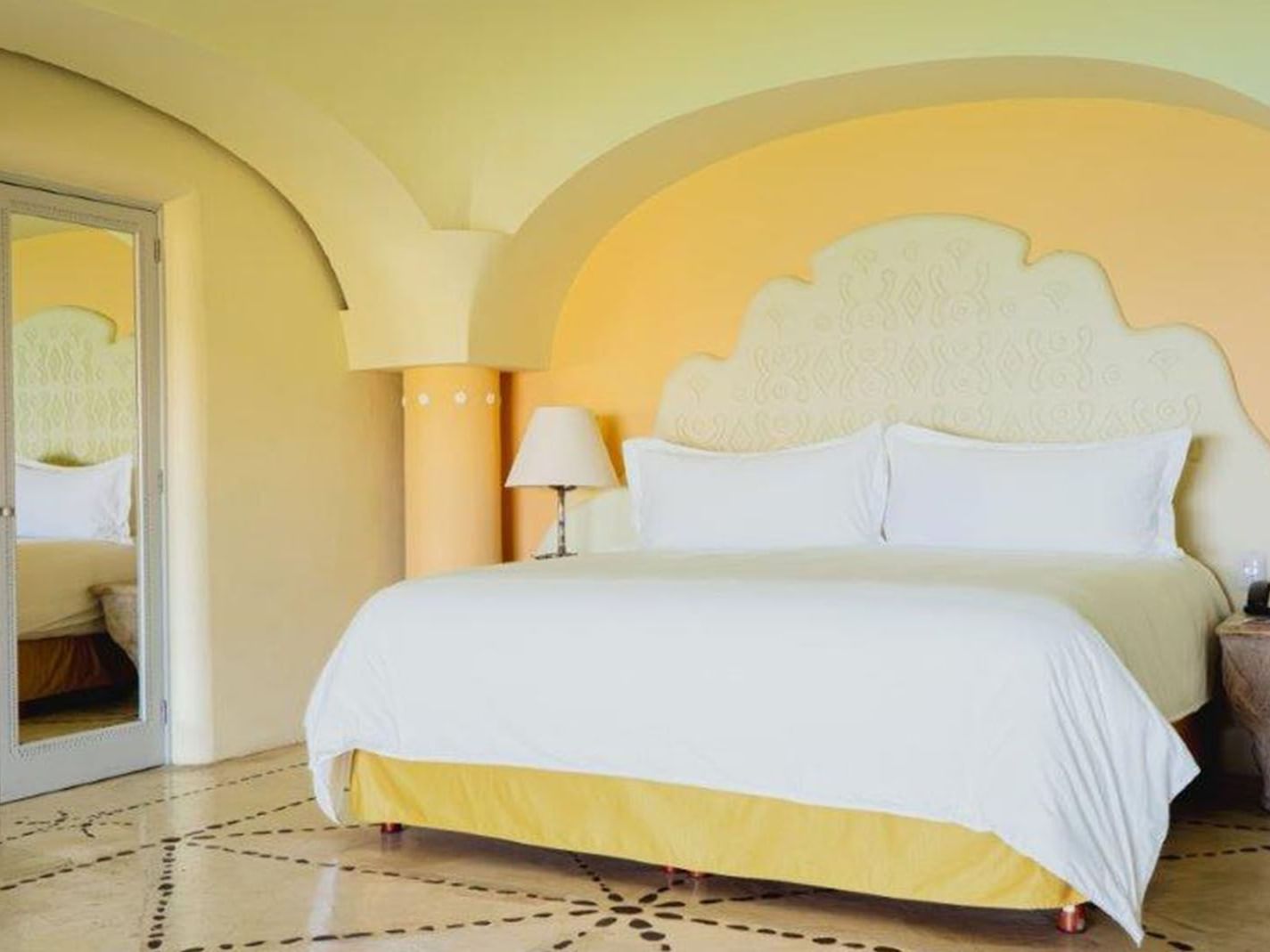 King Grand Class Suite featuring a large arched ceiling and a comfortable king size bed at Quinta Real Huatulco
