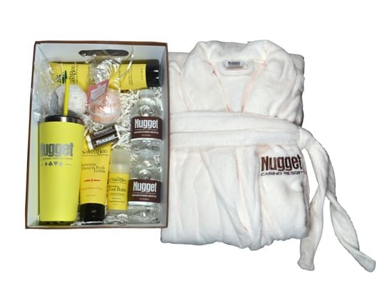A robe with a box of skin care and beauty products