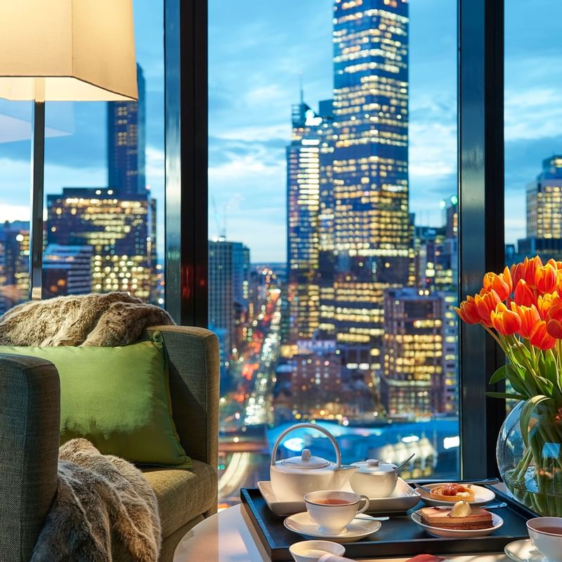 Living room with a city view at Crown Promenade Melbourne