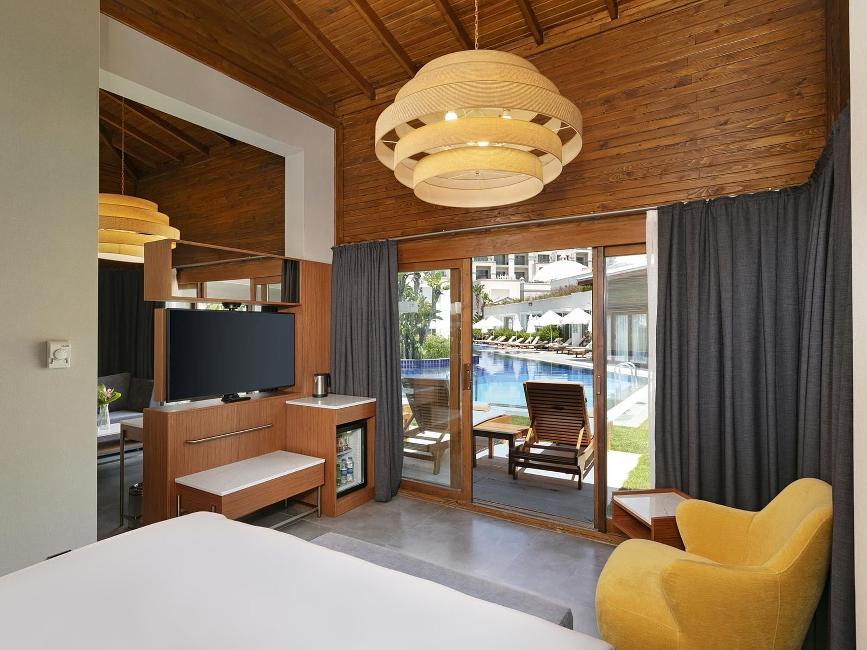 TV lobby area with pool view in Bali House Garden at Titanic Deluxe Golf Belek