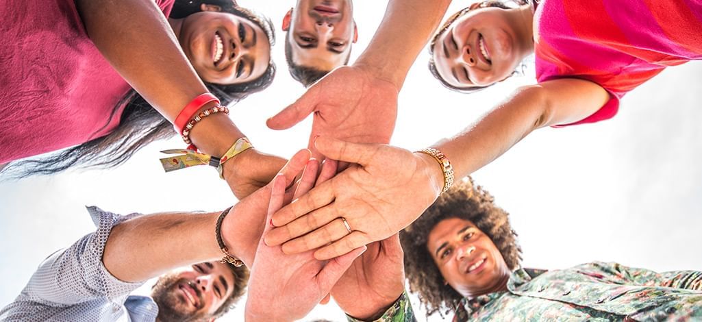 group stacking hands in a circle