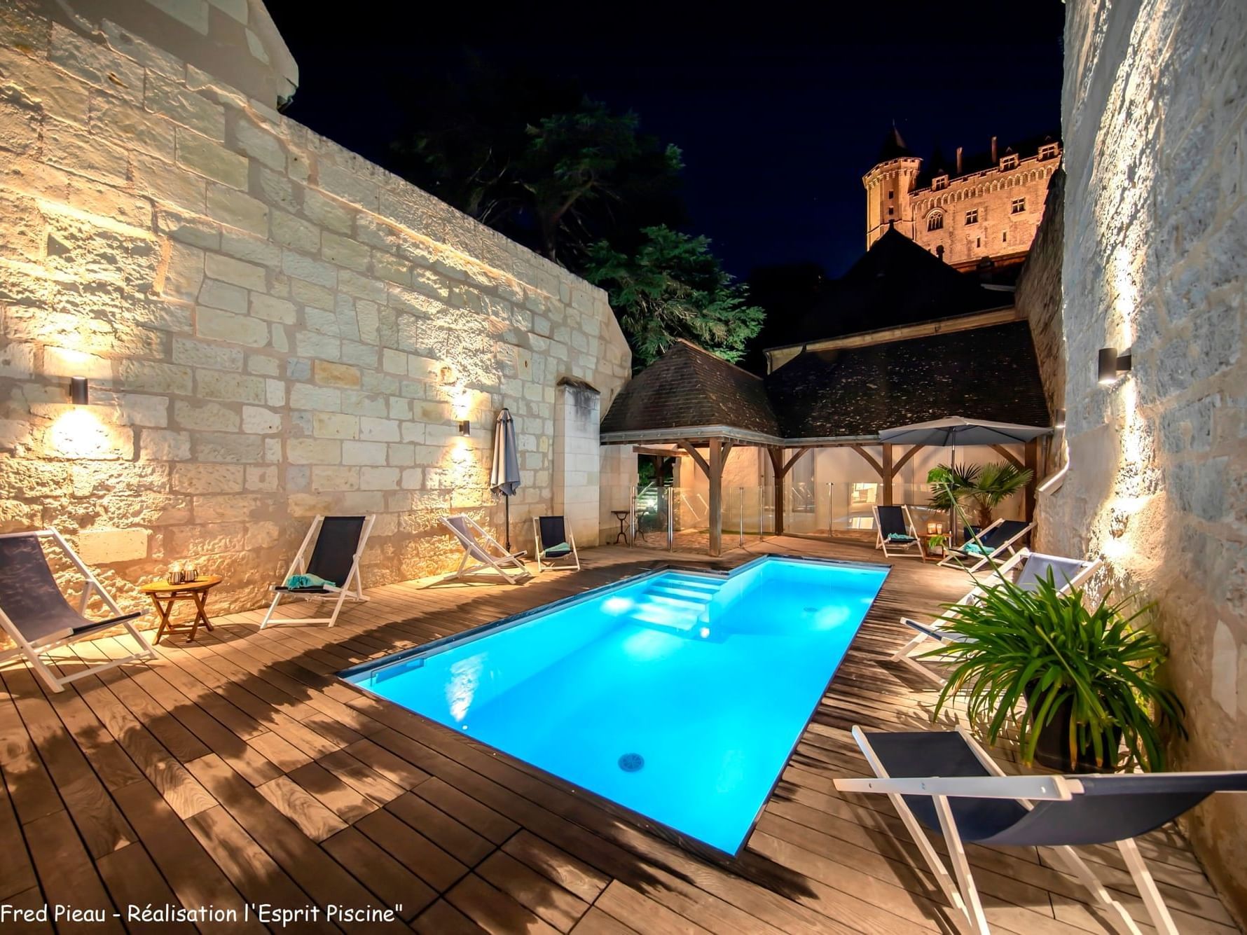 View of an open-air pool at night in hotel Costieres