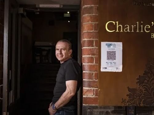 Man leaning against a brick wall in The Mill & Charlie's Bar at Brady Apartment Hotel Hardware Lane