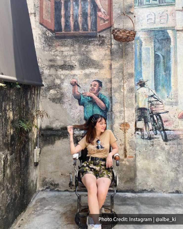 Lady posing by a wall art in Kwai Chai Hong, a local attraction near Imperial Lexis Kuala Lumpur