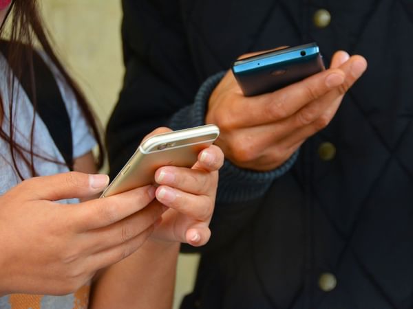 two people with phones in their hands