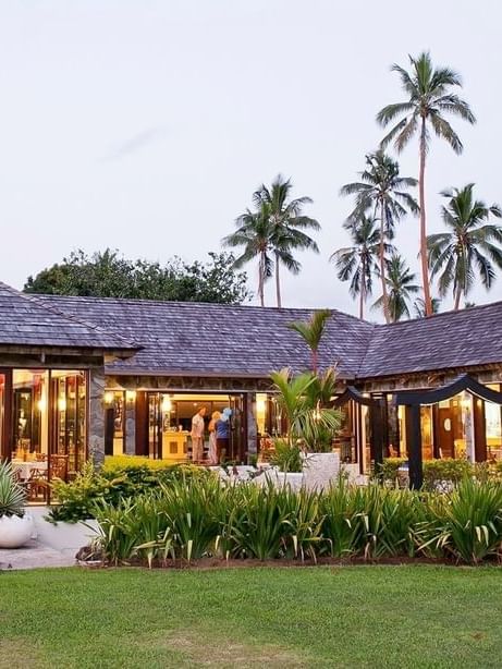 Meeting room by a green lawn under tall palm trees near the garden area at The Naviti Resort - Fiji