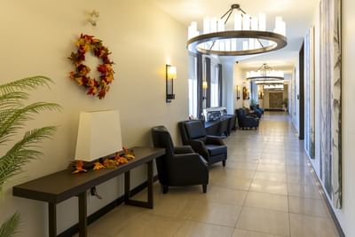 Autumn wreath on a wall by black armchairs at Rodd Miramichi River, a top choice hotel in Miramichi, NB