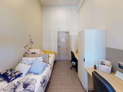 Twin Room with two beds, two desks and two wardrobes at UniLodge Herston.
