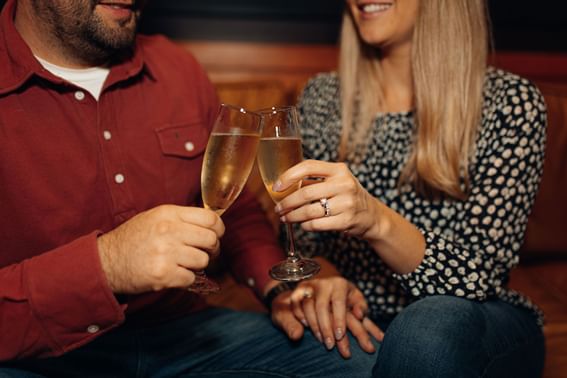 A couple toasting champagne at High Peaks Resort