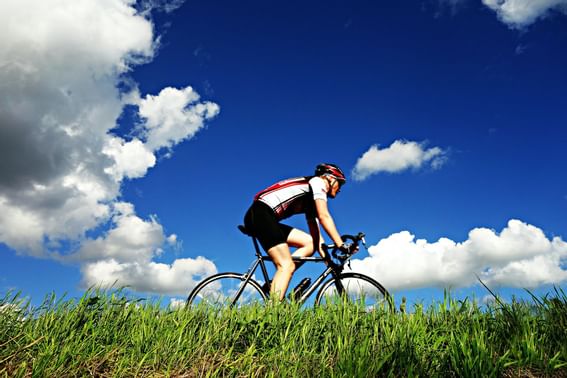 A cyclist riding near The Danna Langkawi