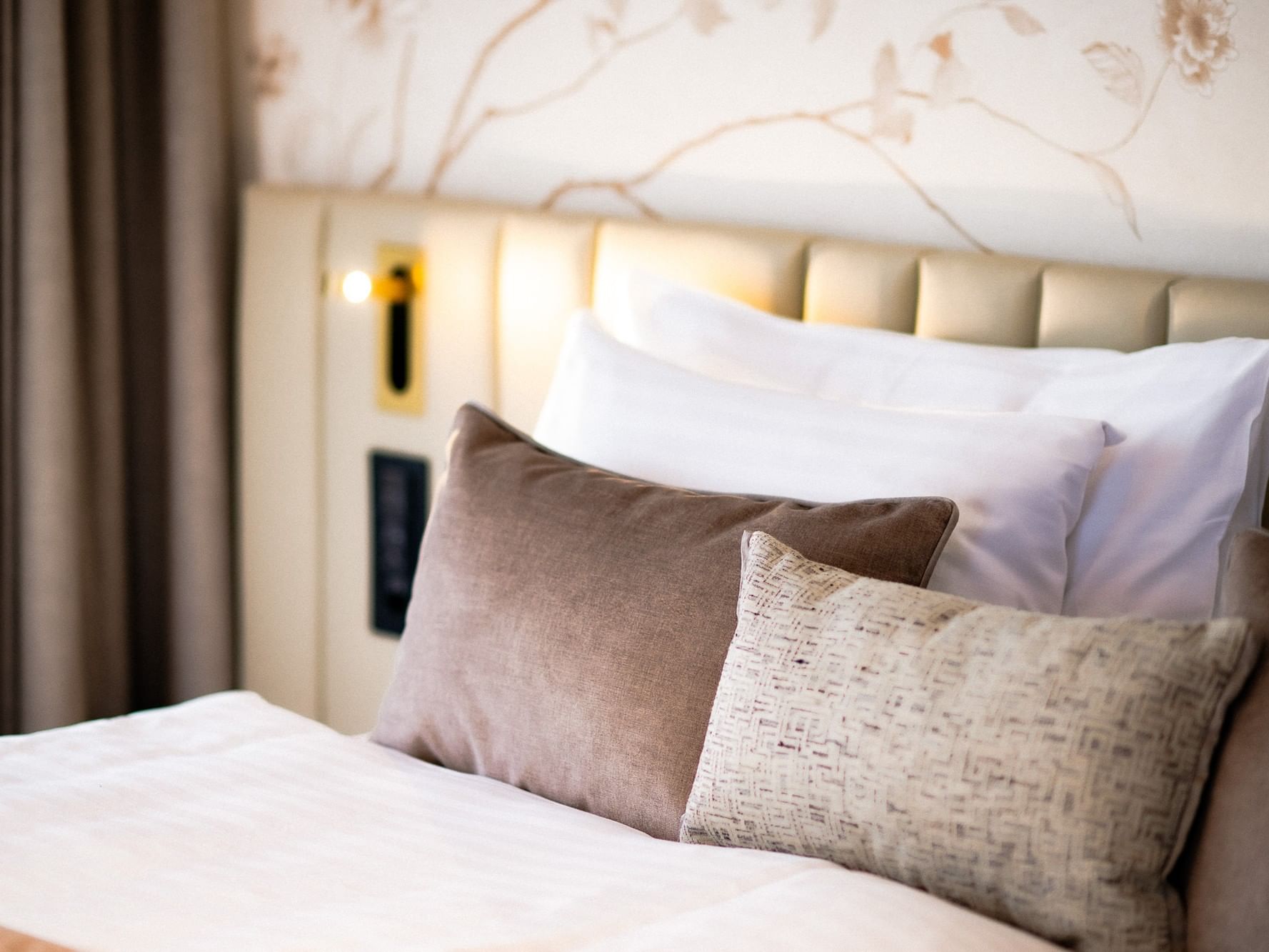 Close-up of cozy bed with cushioned headboard in Junior Suite evasion spa with balconies at Hotel des Innovations