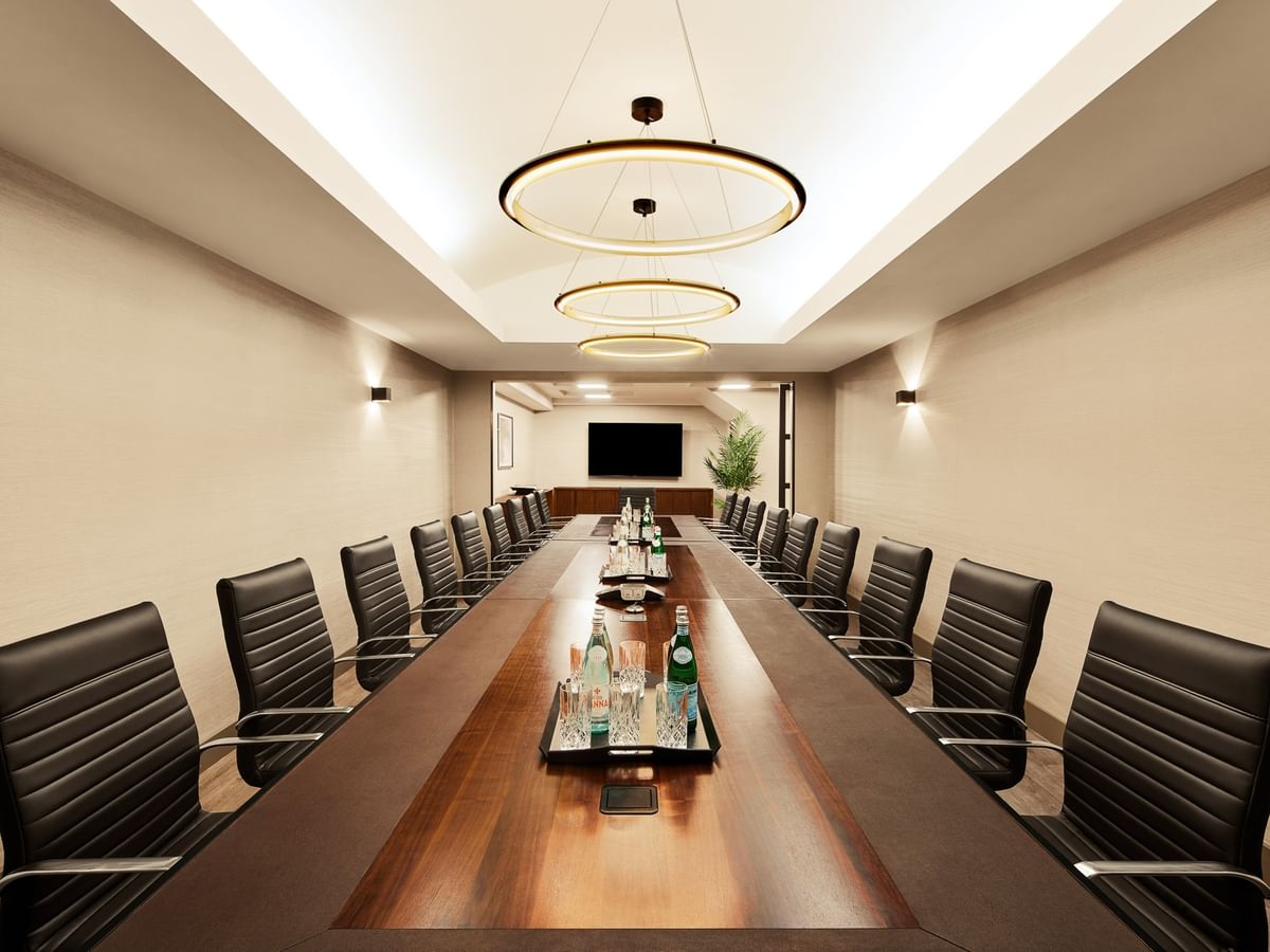Executive Boardroom with long wooden table, black leather chairs, and modern lighting at Gansevoort Meatpacking NYC - NEW.