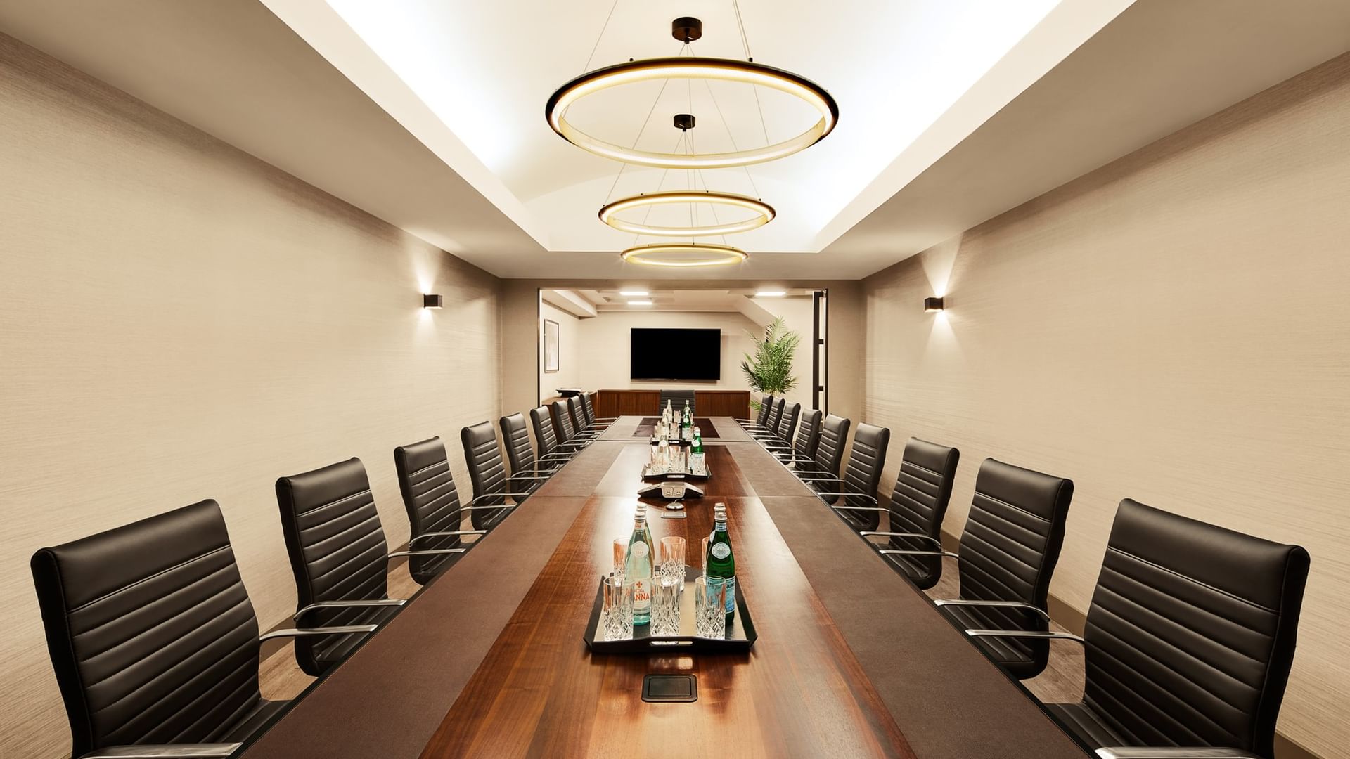 Executive Boardroom with long wooden table, black leather chairs, and modern lighting at Gansevoort Meatpacking NYC - NEW.