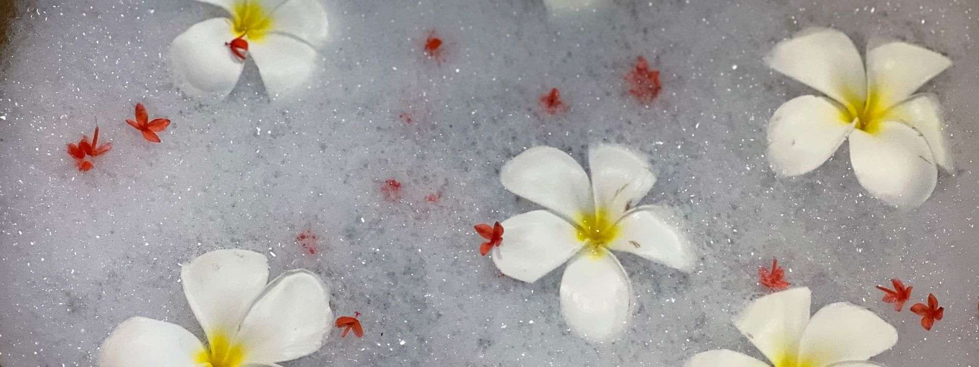 White plumeria flowers floating on a bubble bath at The Joy Spa in Korolevu at The Naviti Resort Fiji