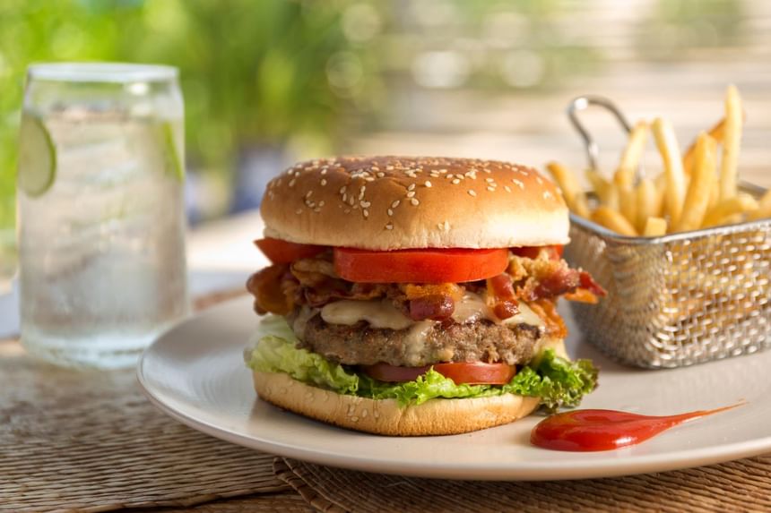 Close-up of a burger & fries served at Marea Beachfront Villas