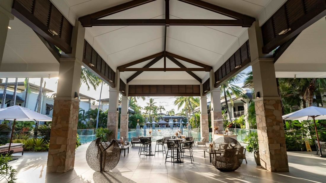 Open-air lobby with elegant seating overlooking pool in Lagoon View Terrace at Pullman Port Douglas