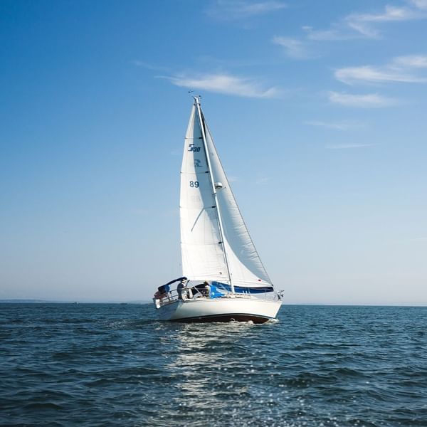 A boat sailing in the sea near Falkensteiner Hotels
