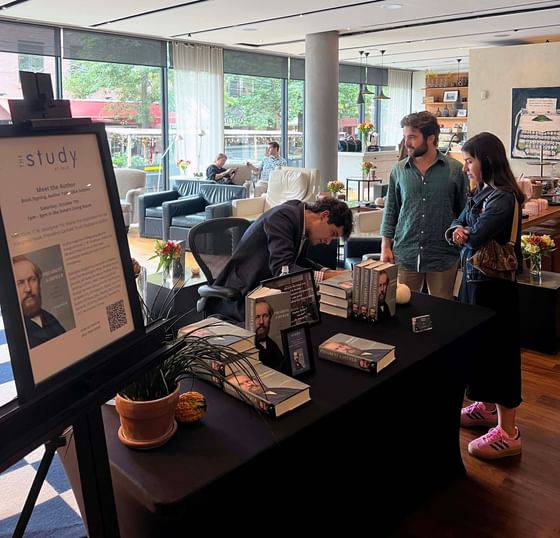 People browsing at indoor book signing event at The Study at Yale