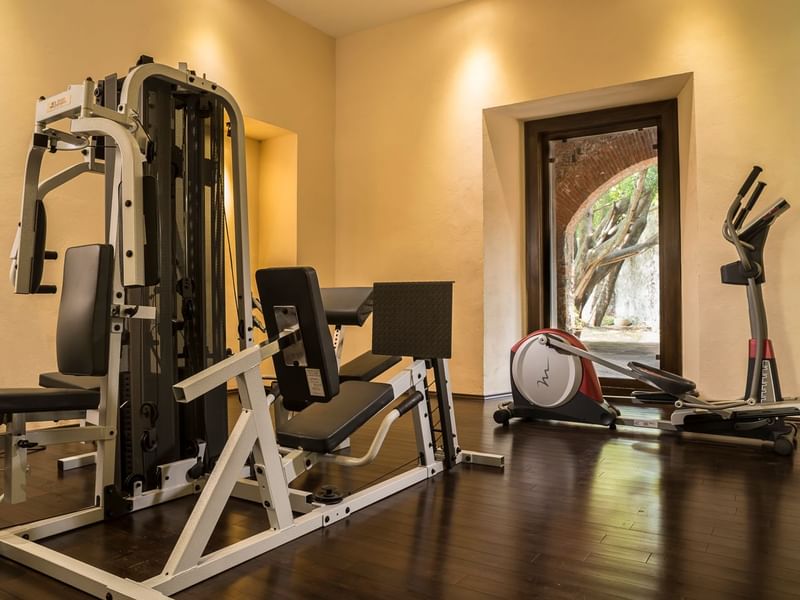 Gym with exercise equipment and a view of an outdoor courtyard at Fiesta Americana