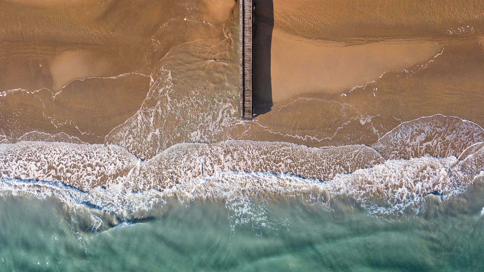 Aerial view of wooden pier extending into the sea at Falkensteiner Hotel & Spa Jesolo