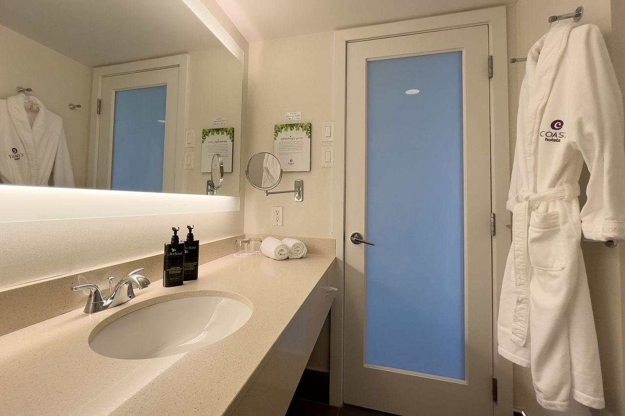 Hotel washroom with sink and housecoat