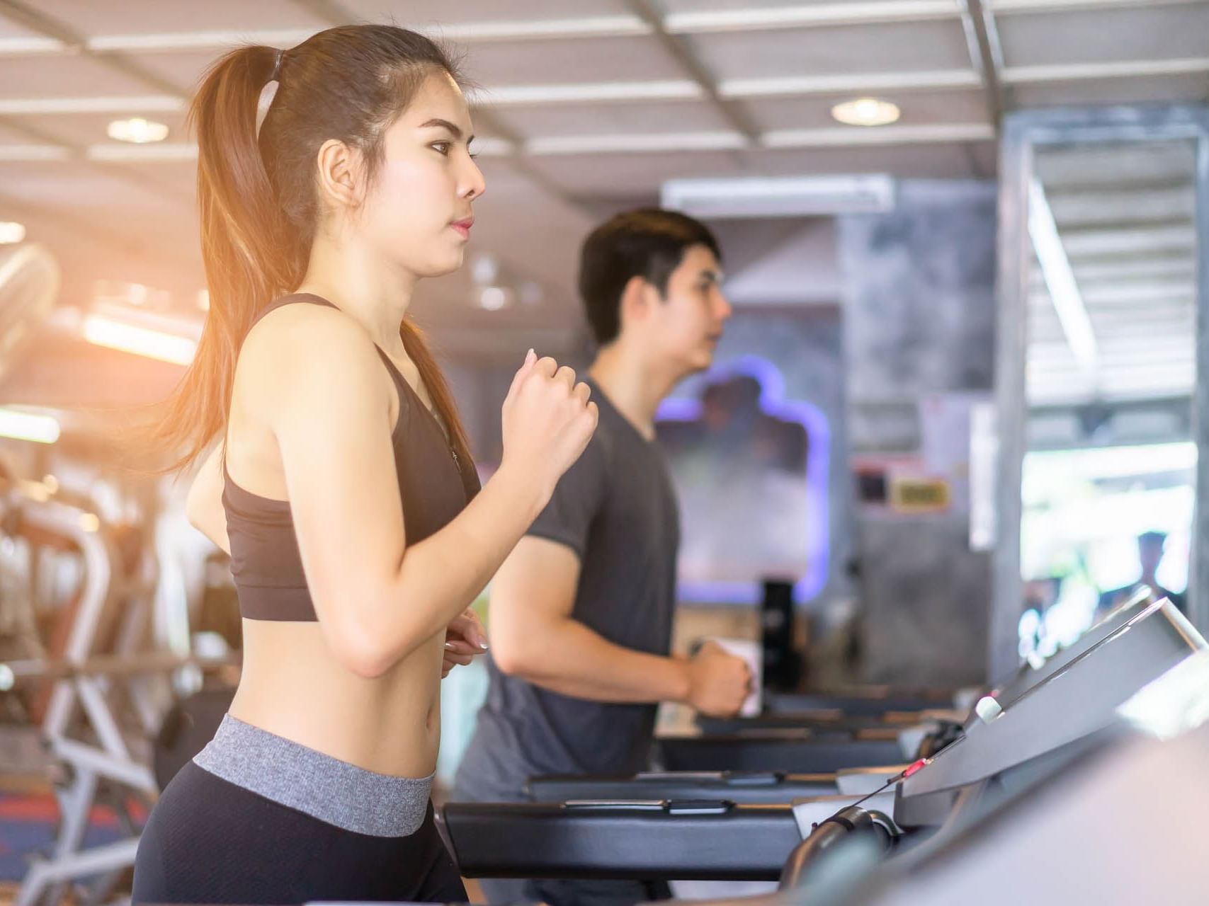 Girl & a boy on treadmills at a gym, Momentus Hotel Alexandra
