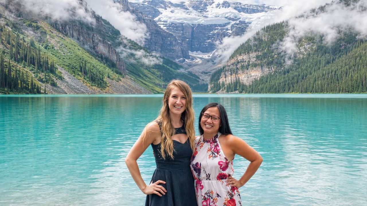 Two friends stop for a picture on a lake outside of Banff.