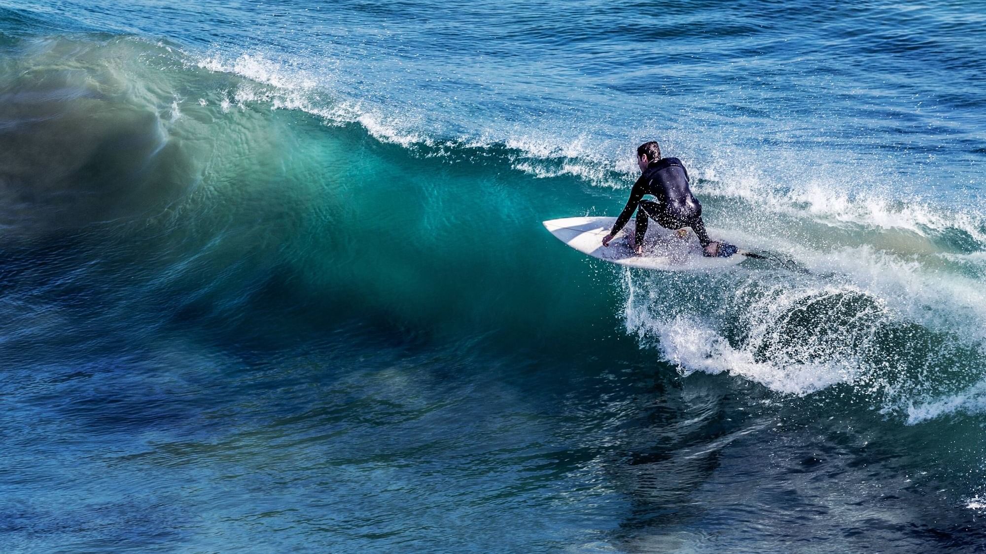 A man surfing on the sea in Biarritz near Originals Hotels