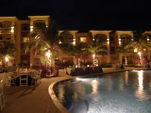 Banquet tables by the pool at Infinity Bay Resort at night