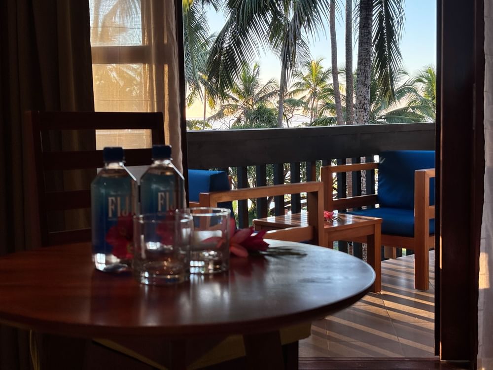Table and balcony with ocean view in Deluxe Double Room at Warwick Fiji Korolevu.