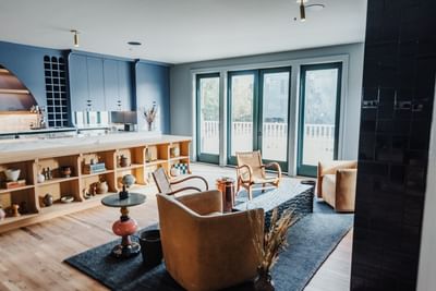 Lounge area seating with the kitchen cabinet and decor items at The Stonebreaker Hotel