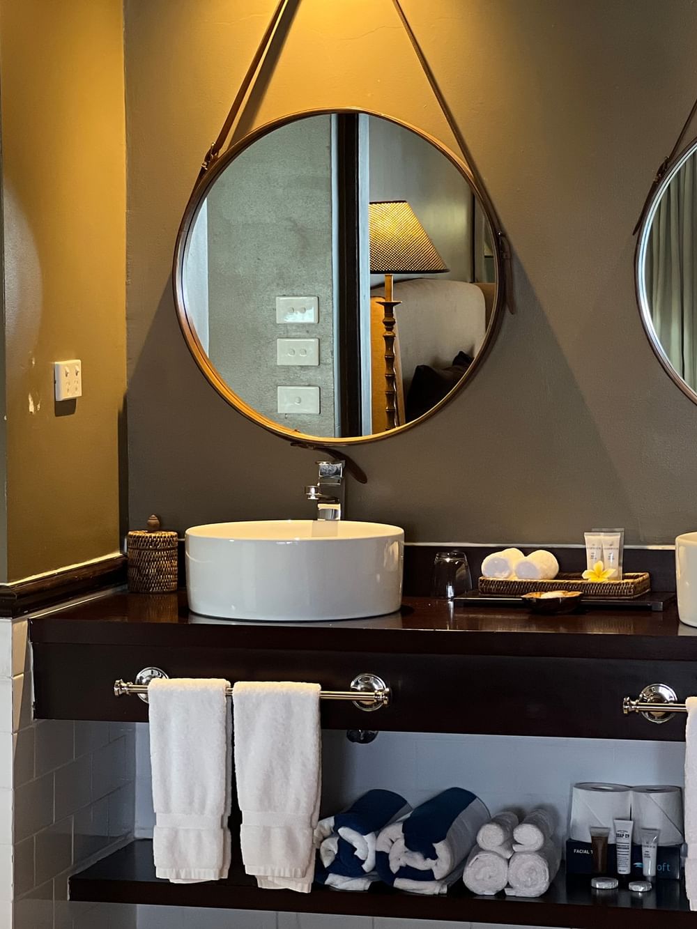 Elegant bathroom with dual sinks and round mirrors at Warwick Le Lagon - Vanuatu, Efate.