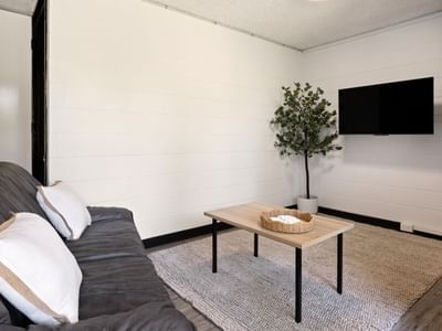 Living room with couch, pillows, and coffee table at UniLodge at Curtin University - Guild House.