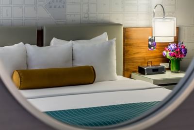 Mirror reflection of a bed in Deluxe King Room at Kinzie Hotel
