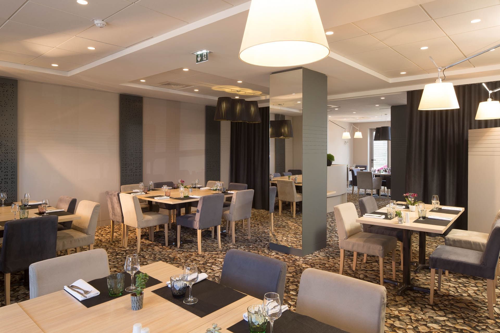 Dining tables arranged in a Restaurant at Oceania Rennes