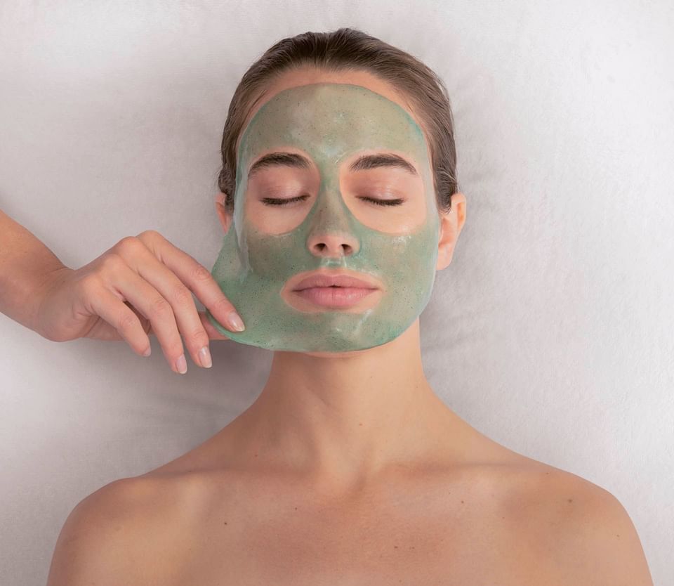 Woman receiving a green mask skincare treatment at Thalgo Spa, The Saujana Hotel Kuala Lumpur