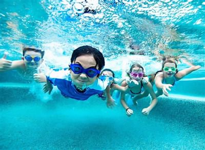 Kids having a dive in the outdoor pool area at Accra Beach Hotel & Spa