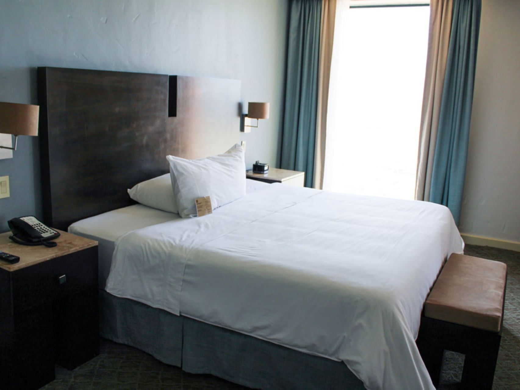 Cozy king bed in Honeymoon Suite at Hotel Coral y Marina