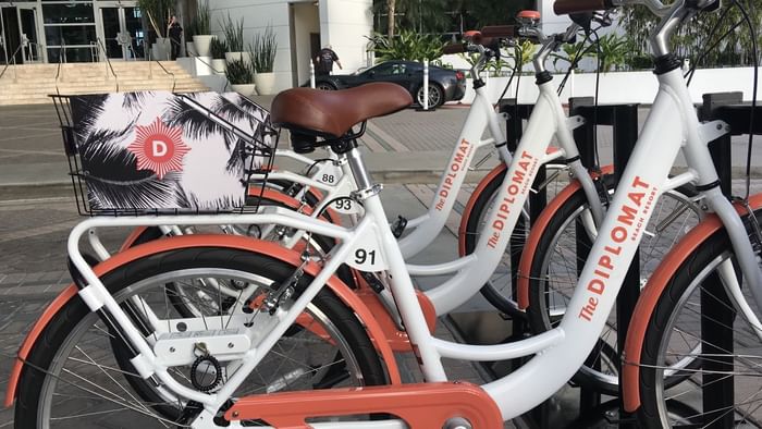 A row of parked bicycles lined up together at The Diplomat Resort