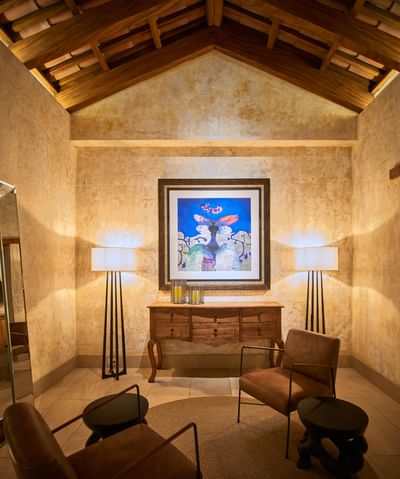 Rustic-chic seating area with a vaulted ceiling & a large painting in Casa Campanas at Singular Signature Residences
