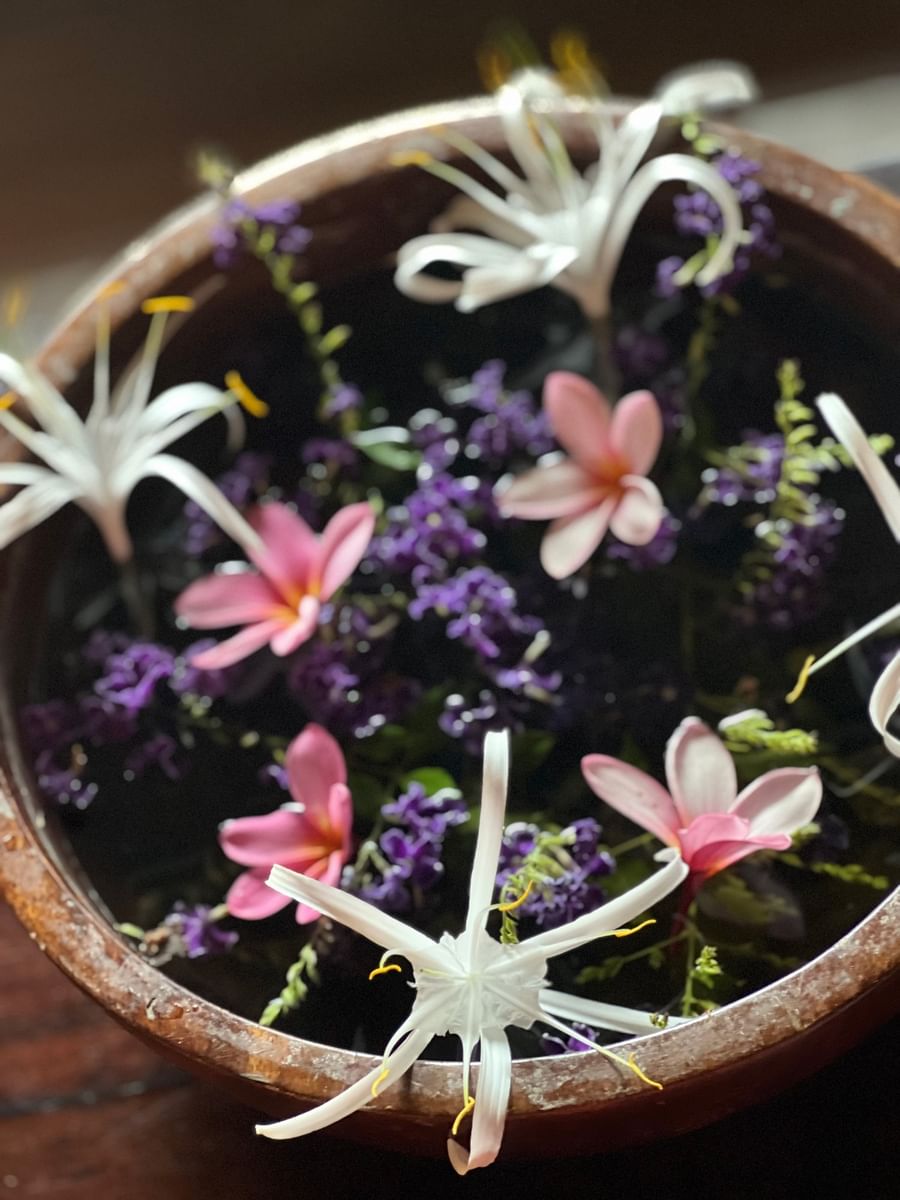 Wooden bowl filled with water and floating flowers at Warwick Le Lagon Vanuatu.