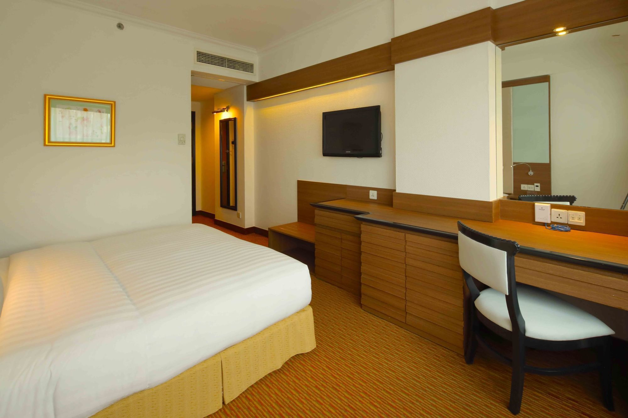 Work desk by the bed in Deluxe City View King at Sunway Hotel Hanoi