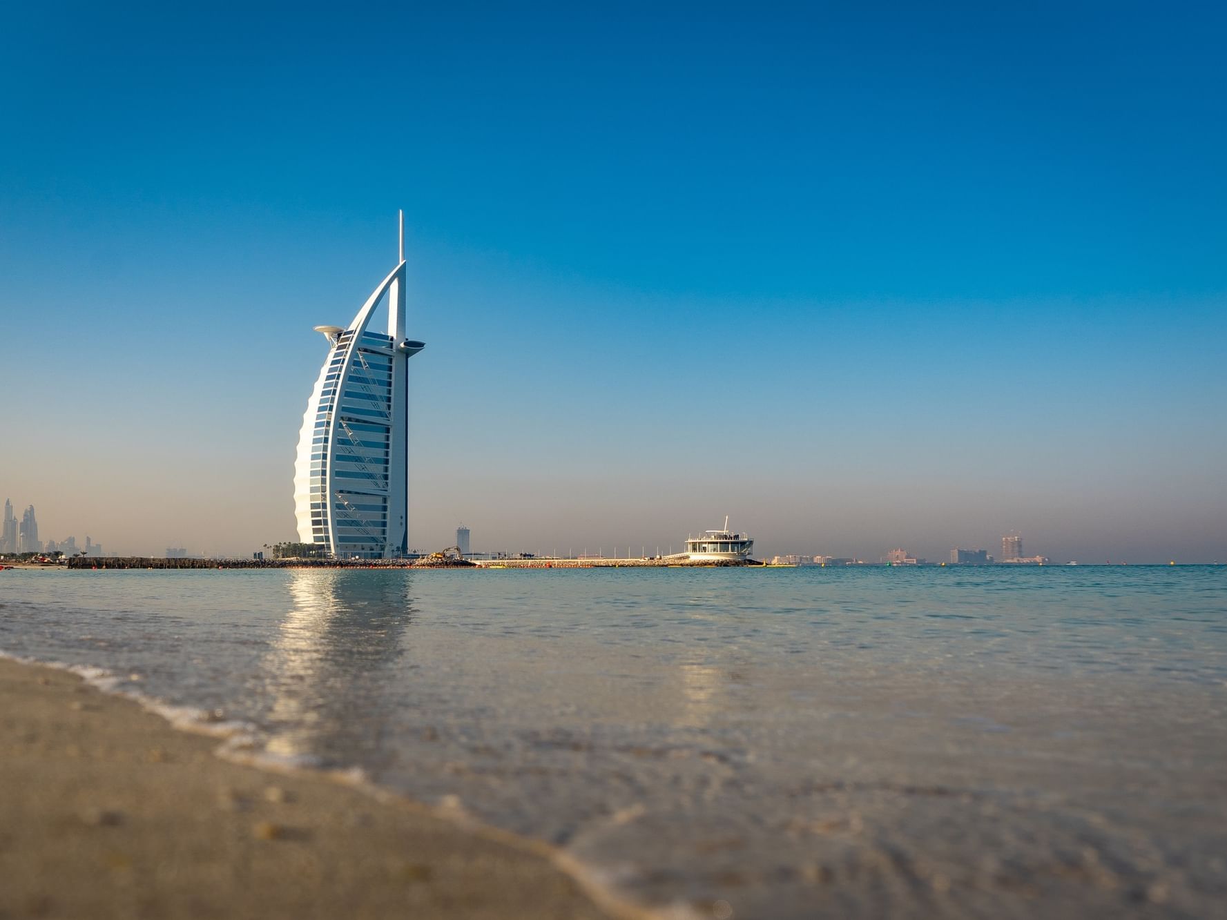 Distant exterior view of Burj Al Arab near City Seasons Hotels