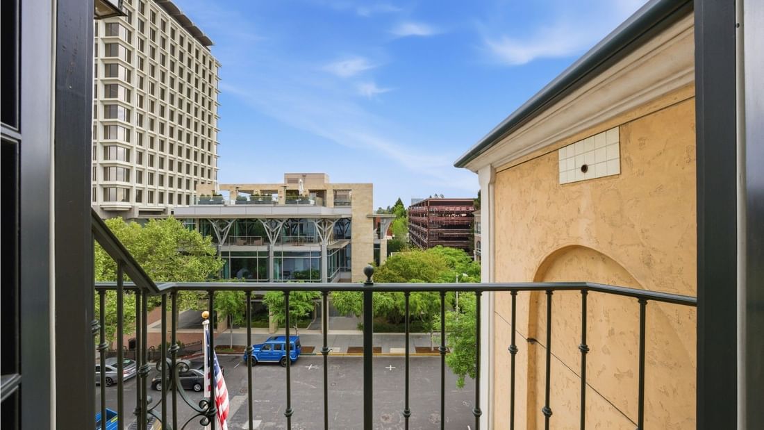 Grand Deluxe Suite balcony view overlooking downtown buildings and parking area at el PRADO Hotel in Palo Alto