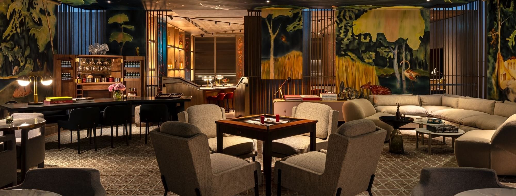 Luxurious lounge at The Residence in The Londoner, featuring elegant seating, abstract murals, and soft lighting