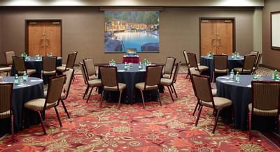 Set banquet tables in event room.